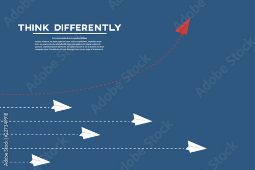 Think different. Think differently concept. Red airplane changing direction. New idea, change, trend, courage, creative solution, innovation and unique way concept. 
