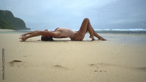 Brunette woman on sendy beach in sweemware photo