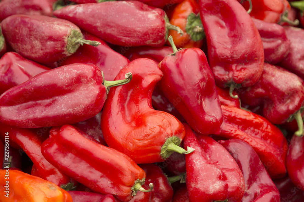 Red sweet peppers closeup as background for design.