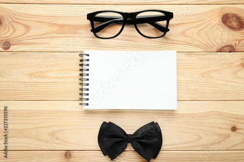 Blank sheet of paper with glasses and bow tie. Boss day concept