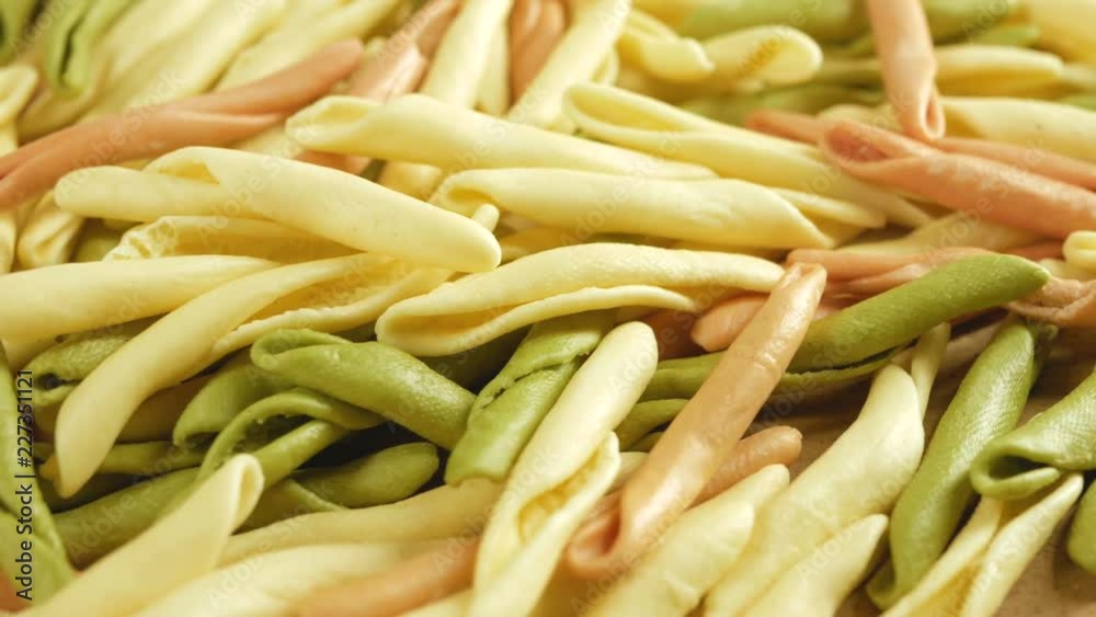 mixed colorfull dry pasta Fusilli, farfalle rotate on wood background mixed colorfull dry pasta Fusilli, farfalle rotate on wood background
