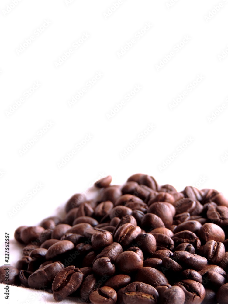 Fototapeta premium Isolated dense bunch or heap of aromatic roasted brown coffee beans