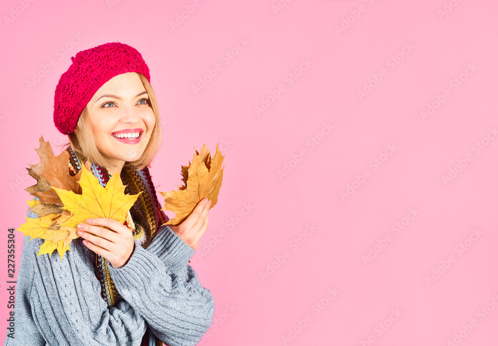 Autumn. Autumn mood. Autumn leaves. Smiling woman holds yellow maple leaves. Woman with autumnal leaves. Yellow maple leaf. Woman holds leaf. Isolated. Warm clothes. Copy space for advertising. Autumn. Autumn mood. Autumn leaves. Smiling woman holds yellow maple leaves. Woman with autumnal leaves. Yellow maple leaf. Woman holds leaf. Isolated. Warm clothes. Copy space for advertising.