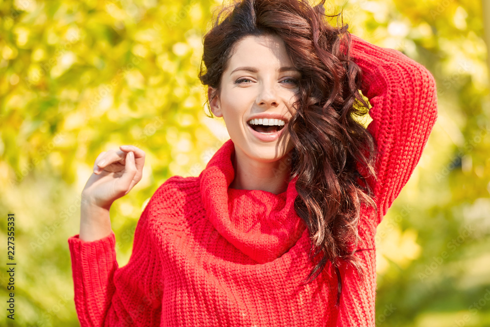 Portrait of beautiful brunette girl. Woman in red sweater. Autumn season Portrait of beautiful brunette girl. Woman in red sweater. Autumn season