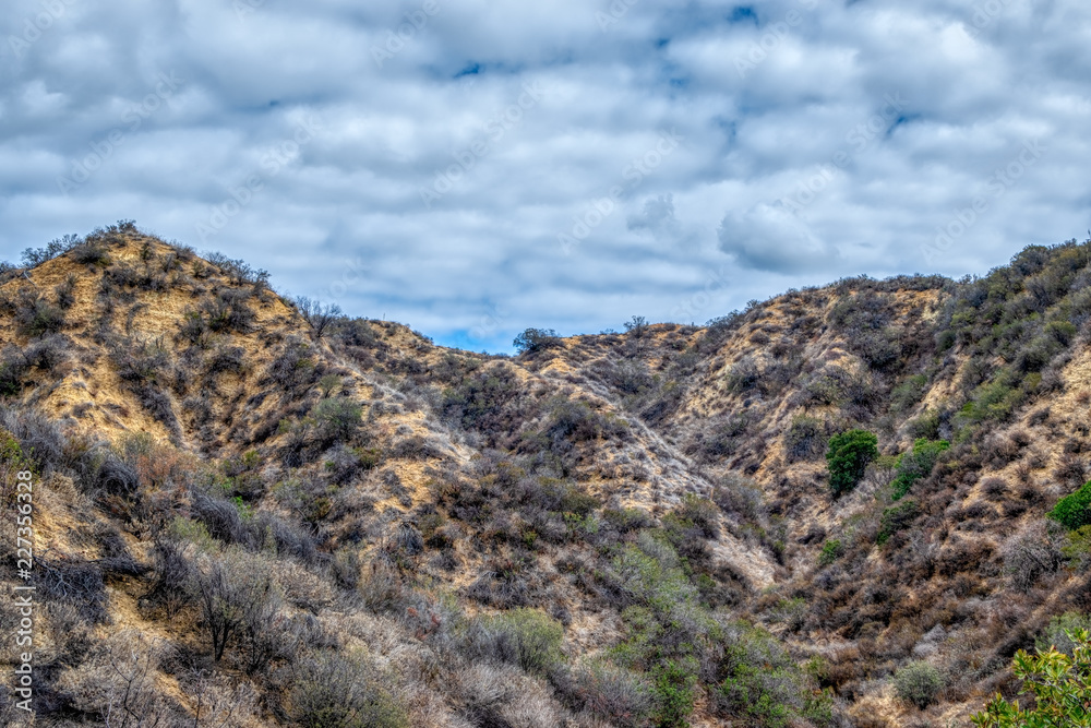 Dry hillsides on inland foothills with morning clouds in the sky Dry hillsides on inland foothills with morning clouds in the sky