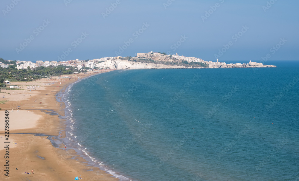 Coastline of the Gargano Peninsula in Puglia, southern Italy, with the town of Vieste on the horizon. Photographed on a clear day in late summer.