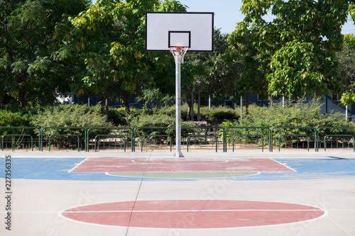 Afroamerican young man playing street basketball in the park