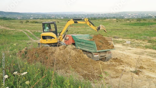 excavator loads a truck