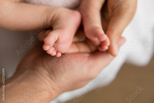 feet newborn in the arms of mother and father. feet of a newborn baby. little foot