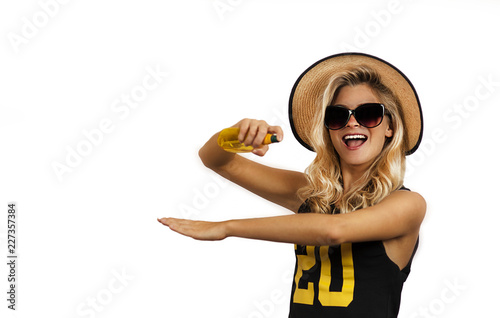 Travel concept. Very beautiful young girl with sunscreen gathered on vacation against a white background.