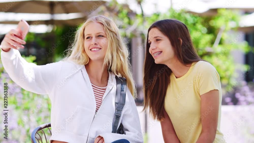 Two Female High School Students Posing For Selfie On Mobile Phone ...