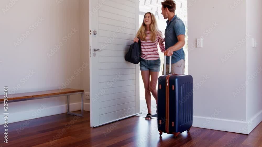 Couple Arriving At Summer Vacation Rental