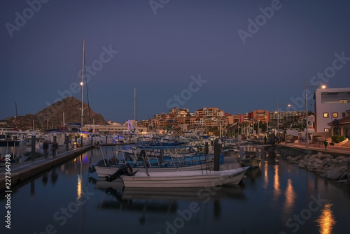Various boats and yachts moored at the marina at night in Los Cabos, Baja California, Mexico