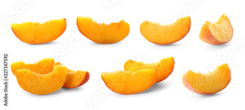 Set with sliced juicy ripe peaches on white background
