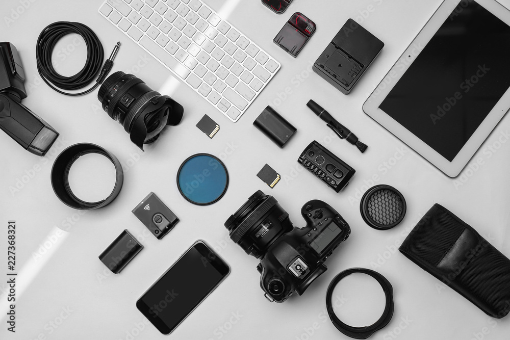 Flat lay composition with equipment for professional photographer on white background Flat lay composition with equipment for professional photographer on white background