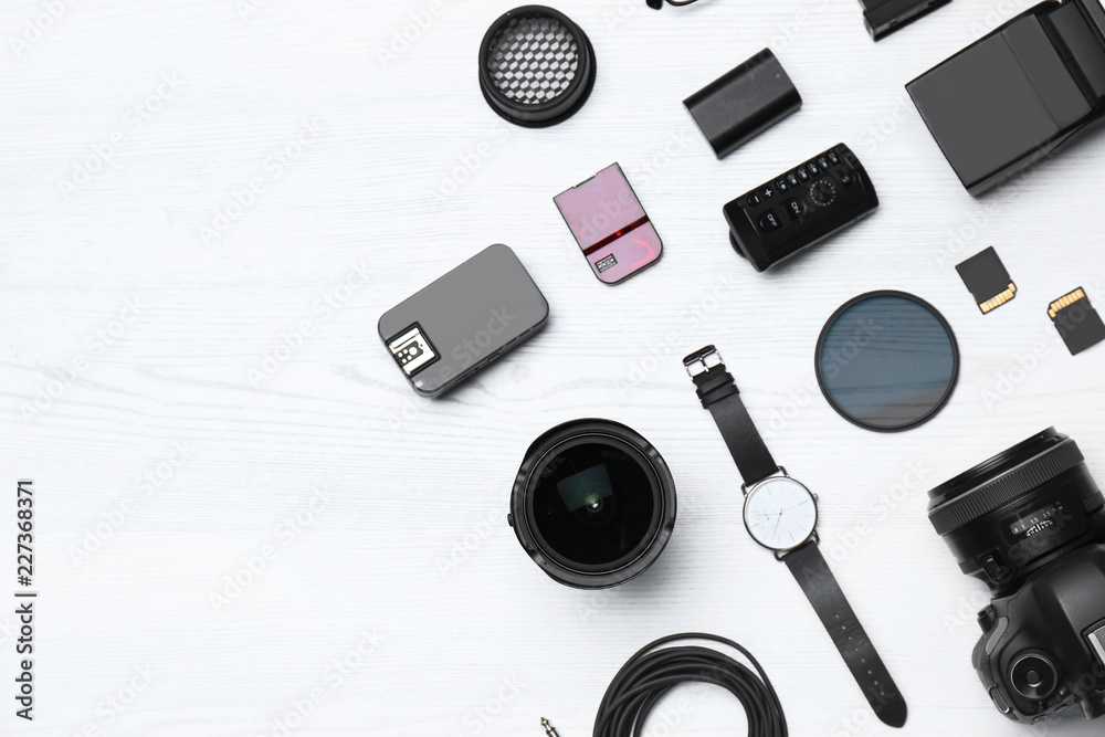 Flat lay composition with equipment for professional photographer on wooden background. Space for text Flat lay composition with equipment for professional photographer on wooden background. Space for text