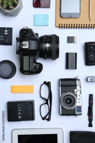 Flat lay composition with equipment for professional photographer on white background