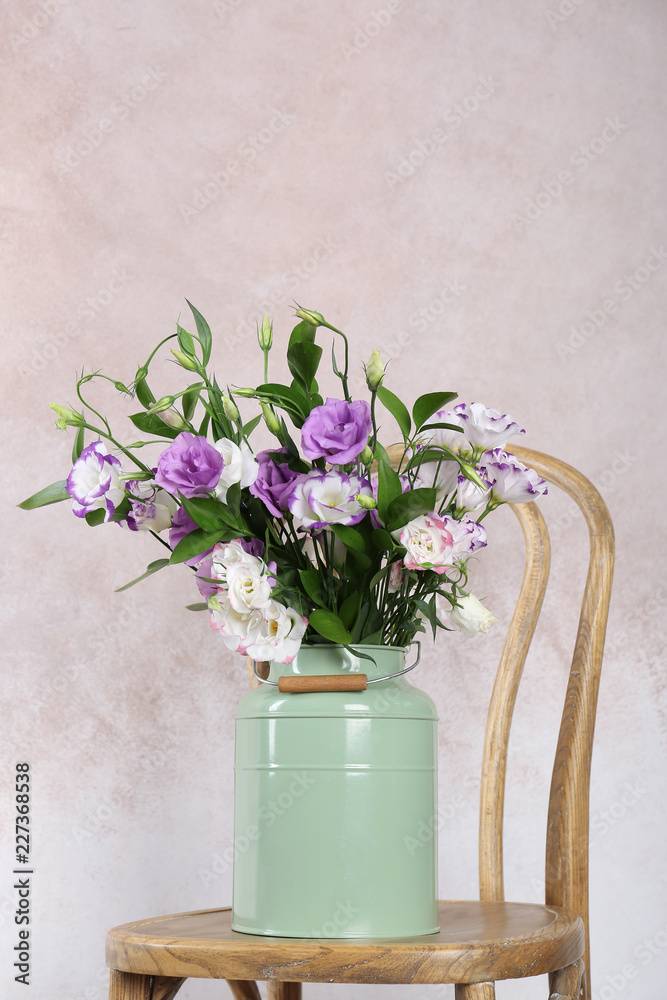 Vase with bouquet of beautiful flowers on chair against color background. Space for text Vase with bouquet of beautiful flowers on chair against color background. Space for text