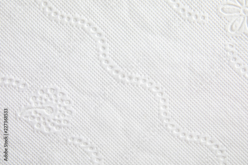 Toilet paper with pattern as background, closeup