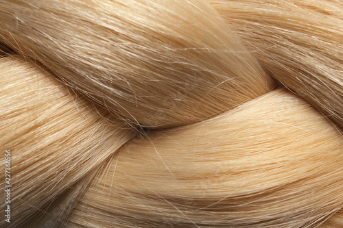 Healthy braided blond hair as background, closeup