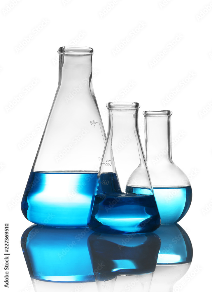Laboratory glassware with liquid on table against white background. Chemical analysis Laboratory glassware with liquid on table against white background. Chemical analysis