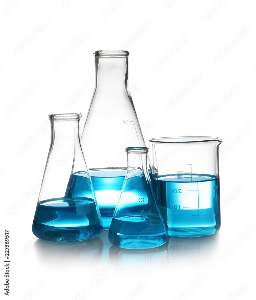 Laboratory glassware with liquid on table against white background. Chemical analysis Laboratory glassware with liquid on table against white background. Chemical analysis