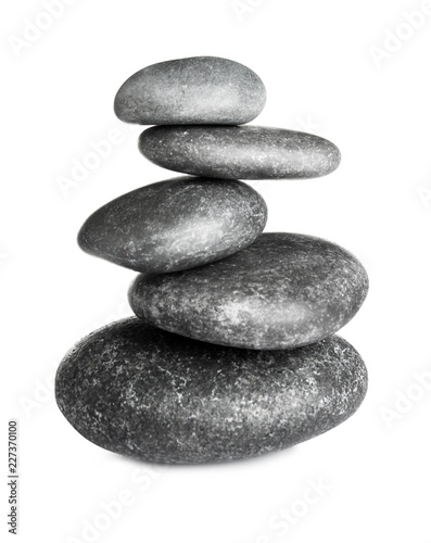 Stack of zen spa stones on white background