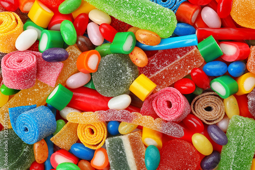 Pile of delicious colorful chewing candies as background
