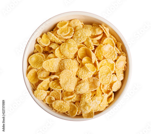 Bowl with crispy cornflakes on white background, top view