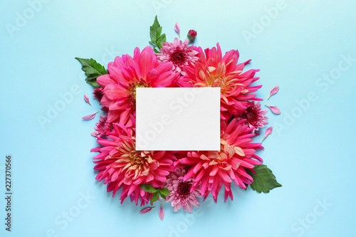 Fototapeta Naklejka Na Ścianę i Meble -  Flat lay composition with beautiful dahlia flowers and blank card on color background