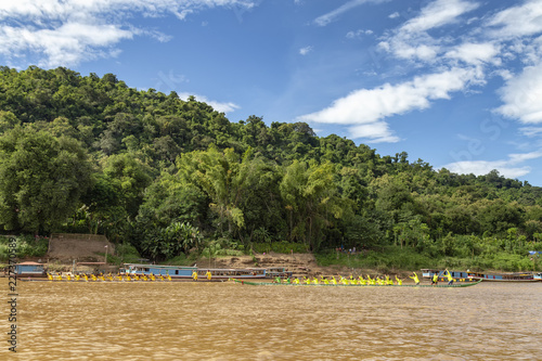 LUANG PRABANG, LAOS - OCTOBER 4: Unidentified people race each other in two boats for an end of Buddhist lent boat race in Luang Prabang, Laos on October 4, 2017.