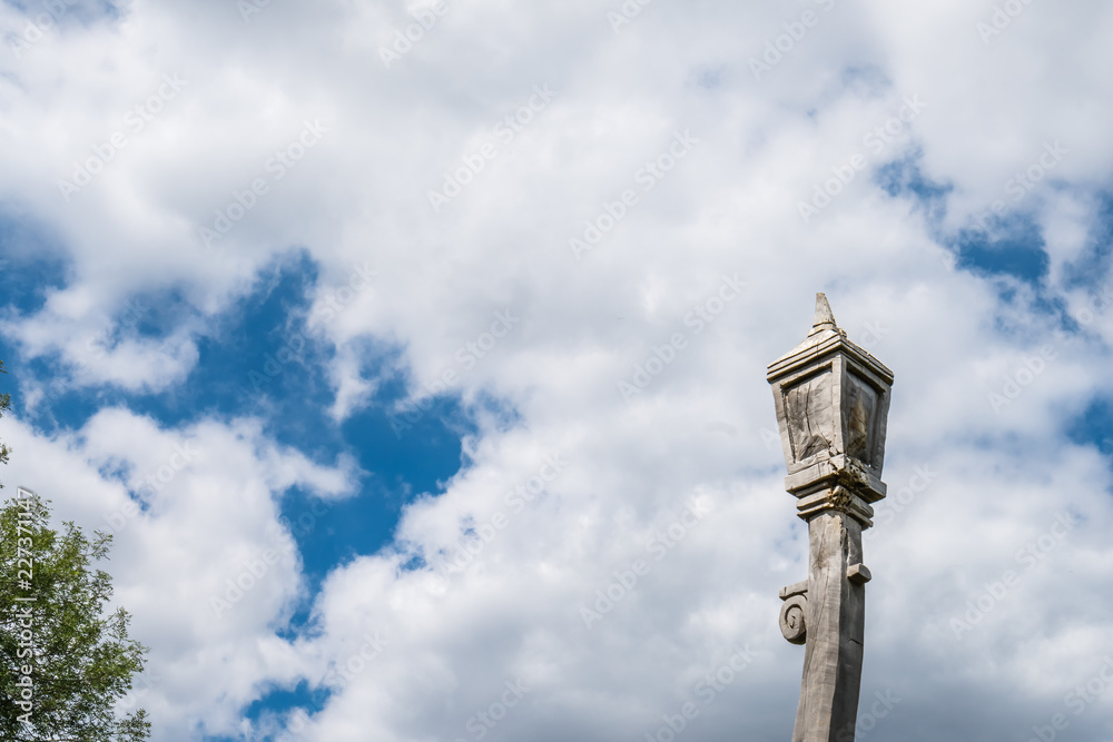 Wooden lantern sculpture and cloudy sky