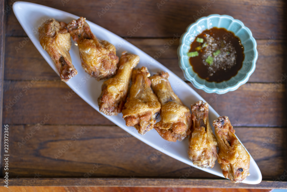 chicken fried and sauce on plate, wood board background. chicken fried and sauce on plate, wood board background.