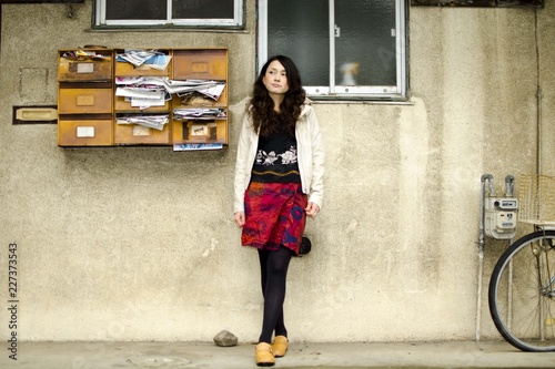 Japanese Girl poses on the street in Fussa, Japan. Fussa is a city located in Tokyo. photo