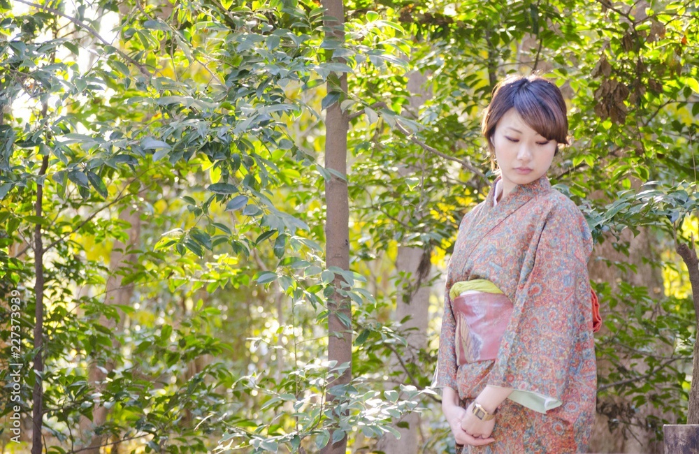 Japanese Girl poses on the street in Kamakura, Japan. Kamakura is an area located in Kanagawa where is a bit south of Tokyo. Japanese Girl poses on the street in Kamakura, Japan. Kamakura is an area located in Kanagawa where is a bit south of Tokyo.