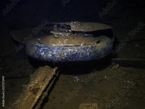 The wheel of a Japanese Mitsubushi Zero fighter in the cargo hold of a ship sunk at Truk Lagoon during World War II photo