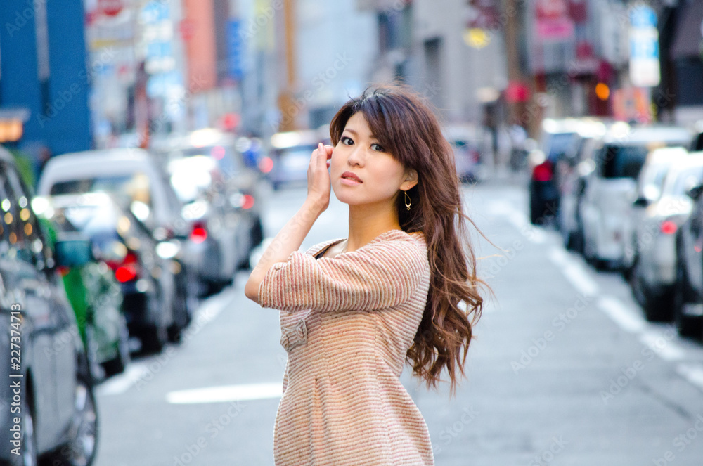 Japanese Girl poses on the street in Ginza, Japan. Ginza is a shopping city located in Tokyo. Japanese Girl poses on the street in Ginza, Japan. Ginza is a shopping city located in Tokyo.