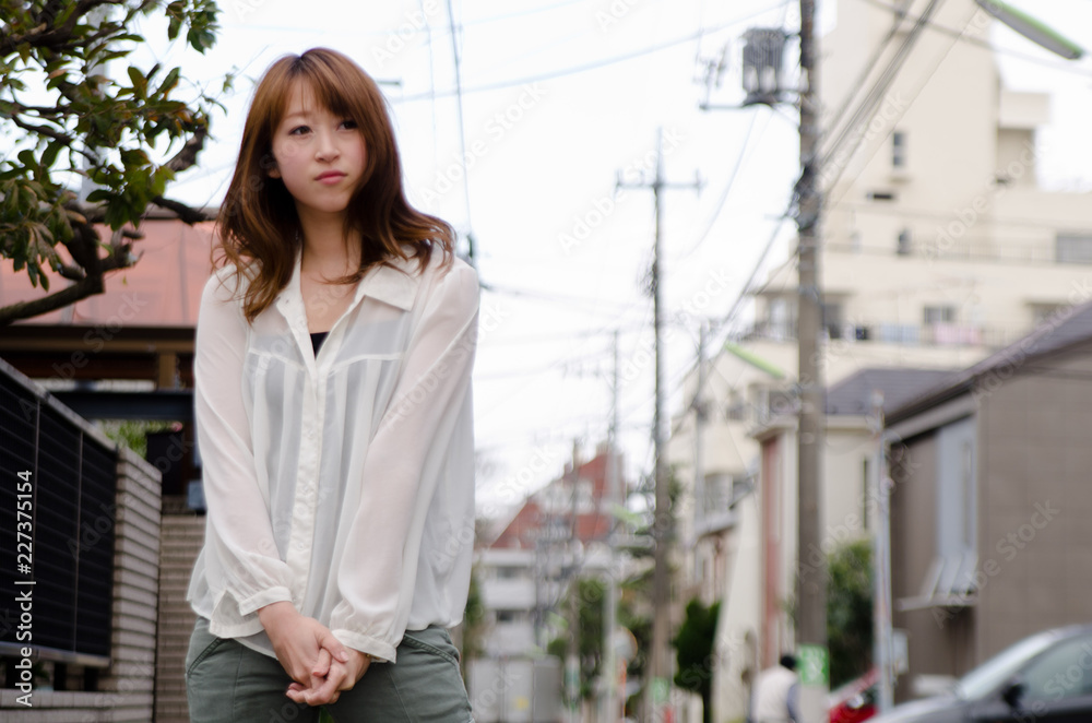Japanese Girl poses on the street in Jiyugaoka, Japan. Jiyugaoka is a town located in Tokyo.