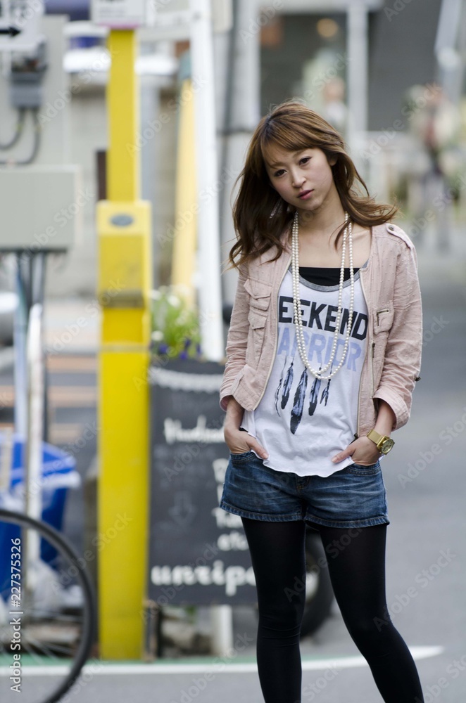 Japanese Girl poses on the street in Jiyugaoka, Japan. Jiyugaoka is a ...