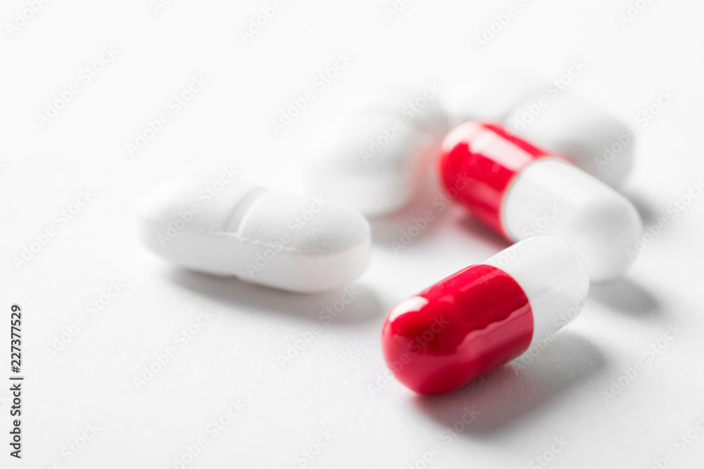 Pharmacy theme, white and red medicine tablets antibiotic pills.