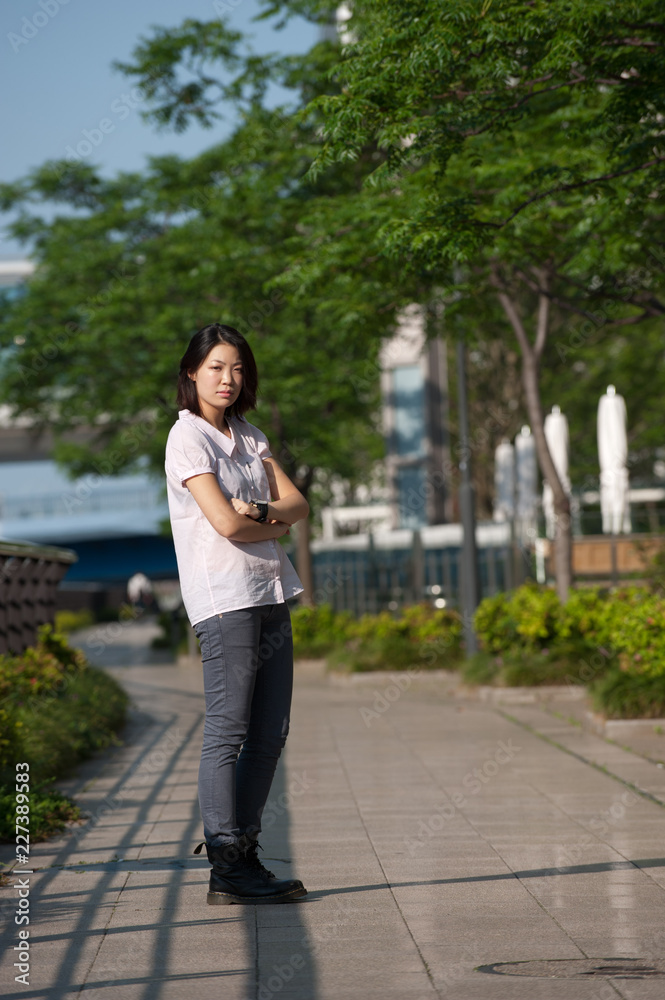Japanese Girl poses on the street in Yokohama, Japan. Yokohama is a port city located in a bit south of Tokyo. Japanese Girl poses on the street in Yokohama, Japan. Yokohama is a port city located in a bit south of Tokyo.