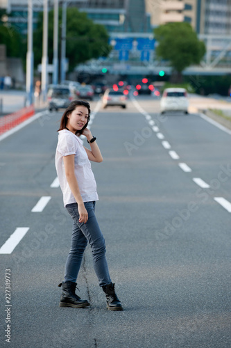 Japanese Girl poses on the street in Yokohama, Japan. Yokohama is a port city located in a bit south of Tokyo.