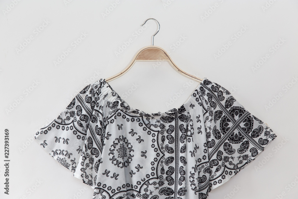 Floral blouse is clothes hanging on white background. Floral blouse is clothes hanging on white background.