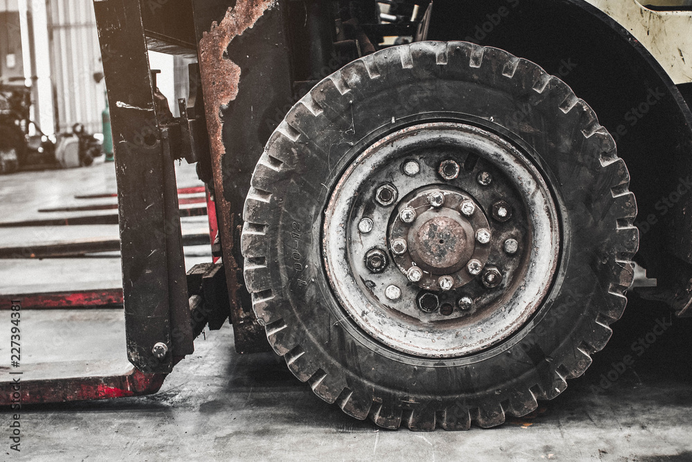 The front wheels of the forklift.