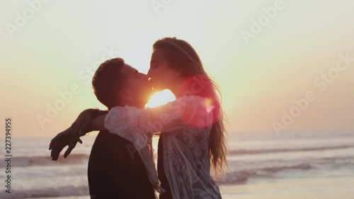 Beautiful couple in love kissing on seacoast