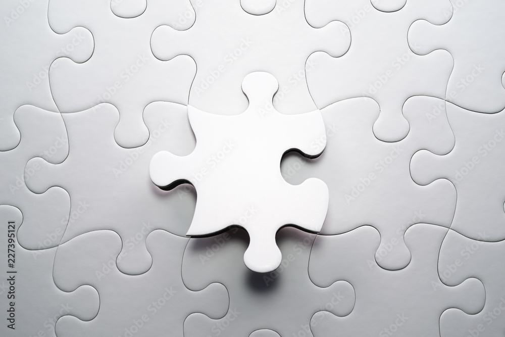 The correct solution. Solving and completing the task.Last piece of jigsaw puzzle. Assembling white jigsaw puzzle pieces. The correct solution. Solving and completing the task.Last piece of jigsaw puzzle. Assembling white jigsaw puzzle pieces.