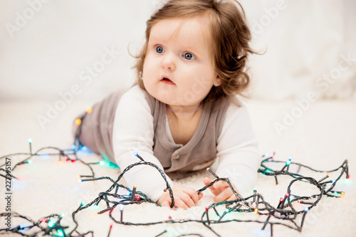 baby in the new year lights on the carpet