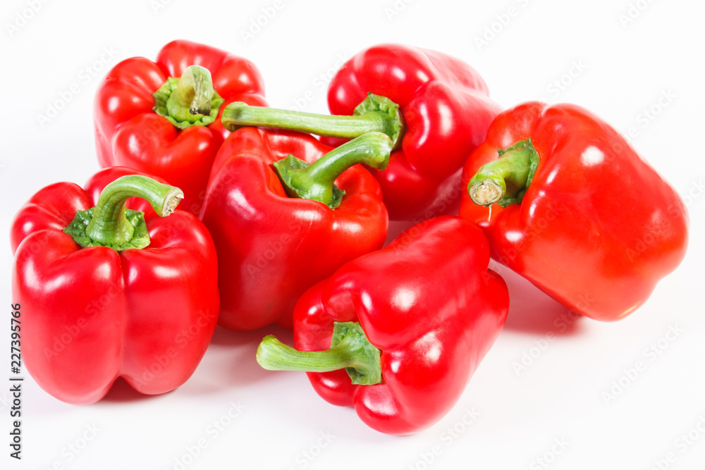 Fresh red peppers lying on white background, healthy nutrition concept Fresh red peppers lying on white background, healthy nutrition concept