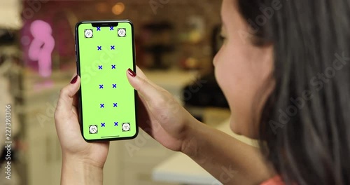 Woman using green screen phone