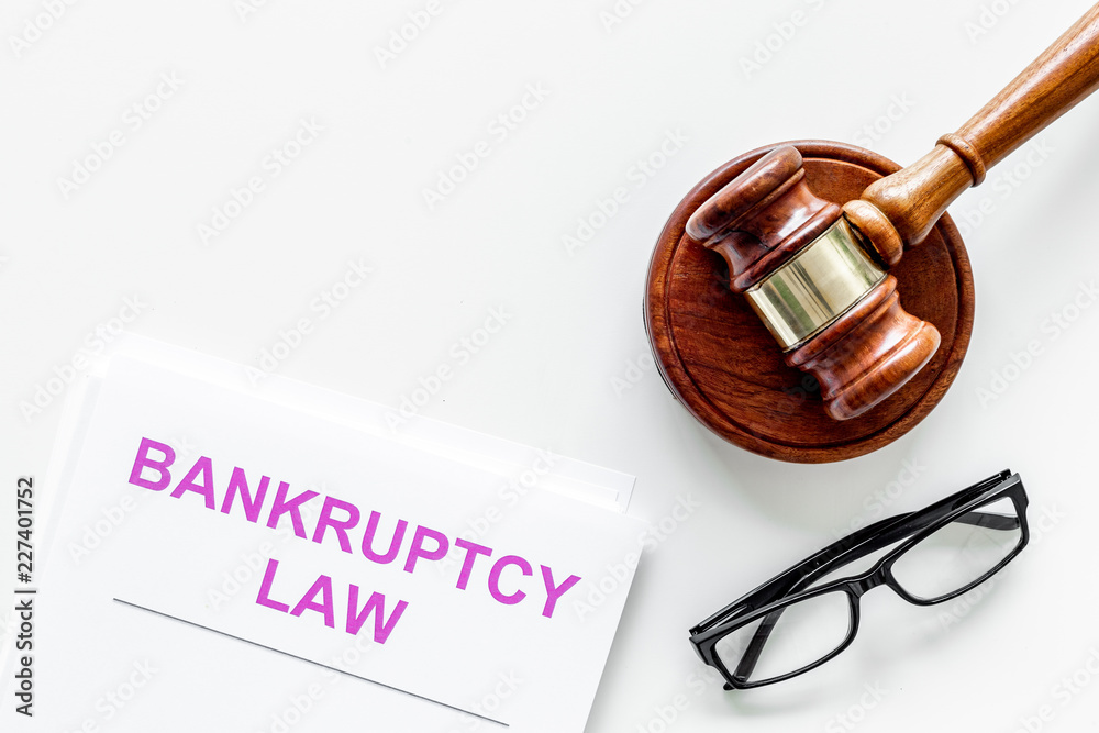 Words bankruptcy law written on the documents near judge gavel on white background top view space for text Words bankruptcy law written on the documents near judge gavel on white background top view space for text